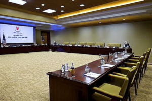 Conference room at Camp David style retreat, empty chairs and official setting for defense briefing